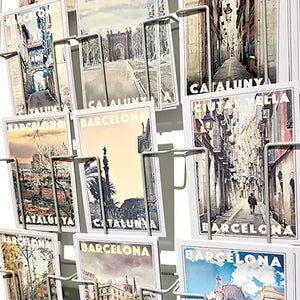 Barcelona postcards in vintage travel style displayed on a rack, featuring iconic landmarks in limited edition by MyRetroPoster