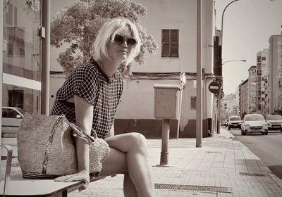 Black and white portrait of Cha, illustrator and co-founder of Myretroposter, sitting in Palma de Mallorca. A mother and retro poster artist known for collections like Soft Pop Studio™, Vintage Exotics™, and The Great Indian Décor™