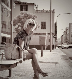 Black and white portrait of Cha, illustrator and co-founder of Myretroposter, sitting in Palma de Mallorca. A mother and retro poster artist known for collections like Soft Pop Studio™, Vintage Exotics™, and The Great Indian Décor™
