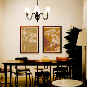 Japanese inspired botanical prints from The Herbarium series by Cha, displayed in a warm contemporary interior with earthy colours and decorative floral compositions.