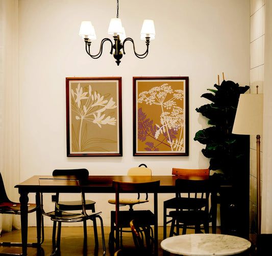 Japanese inspired botanical prints from The Herbarium series by Cha, displayed in a warm contemporary interior with earthy colours and decorative floral compositions.
