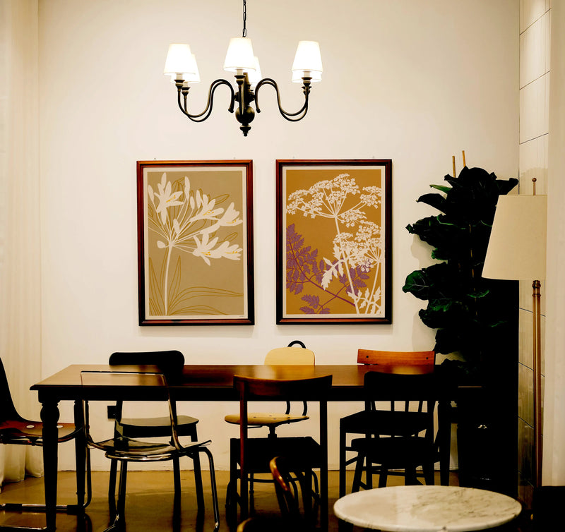 Japanese inspired botanical prints from The Herbarium series by Cha, displayed in a warm contemporary interior with earthy colours and decorative floral compositions.