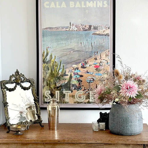 Cala Balmins Sitges limited edition poster by Alecse styled with vintage decor and floral arrangement