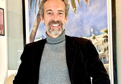 Portrait of Alecse, vintage travel poster artist in his Sitges gallery