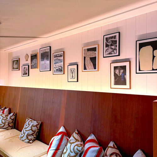 Framed St Barth St Jean vintage travel poster by Alecse displayed inside a luxury hotel in Gustavia, St Barth, shown in a refined black and white tonal version.