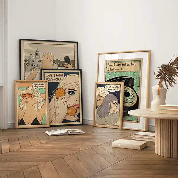 Framed comic-style posters from the Soft Pop Studio™ collection by Cha displayed in a cozy modern interior, featuring retro female portraits with humorous quotes and muted pastel tones.