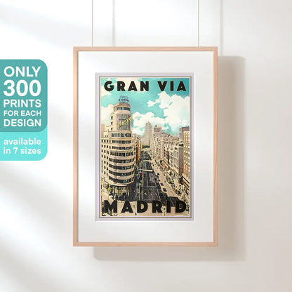 Framed vintage travel poster of Madrid Gran Vía hanging on white wall