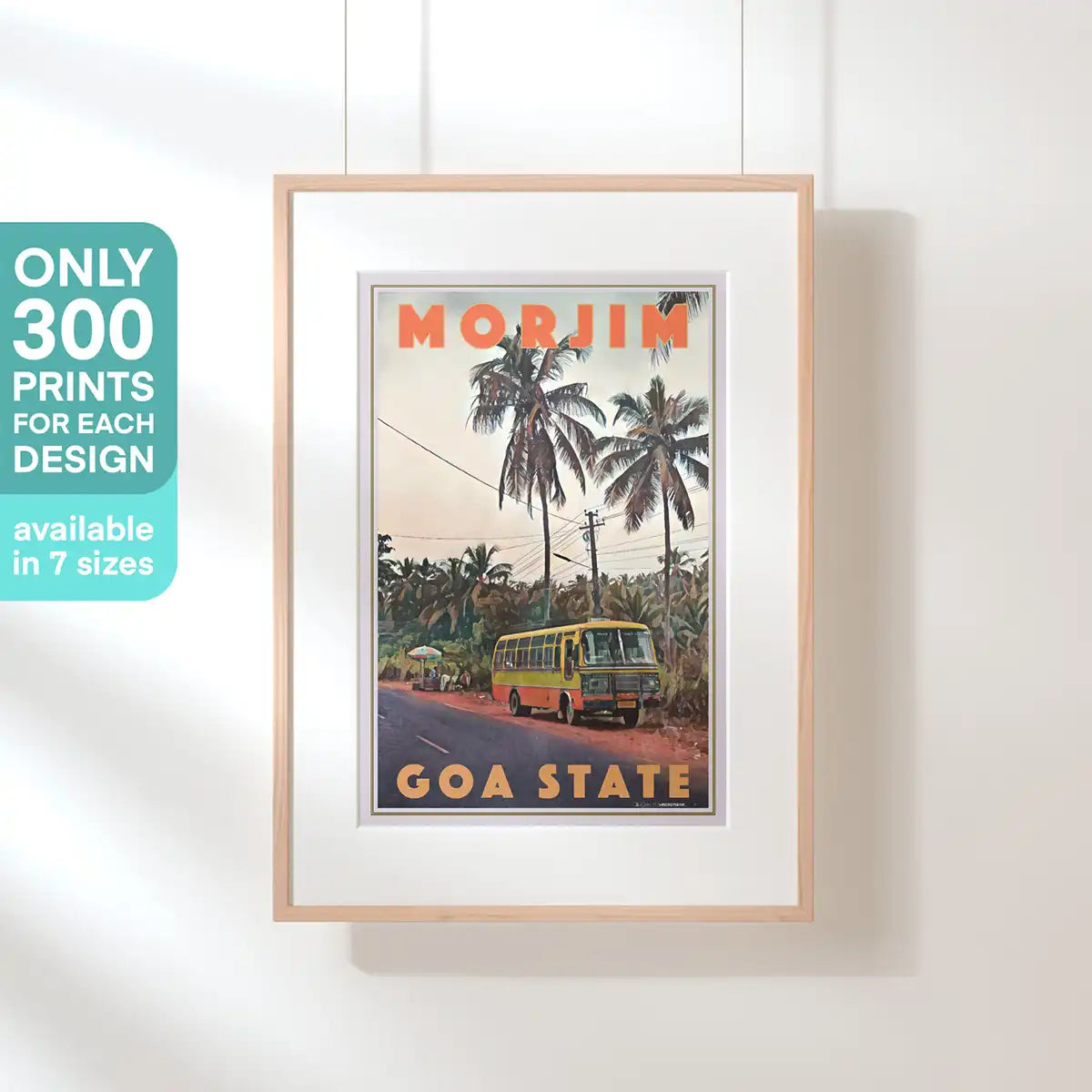 Framed Morjim Goa vintage travel poster featuring a tropical roadside scene with palm trees and a classic Indian bus