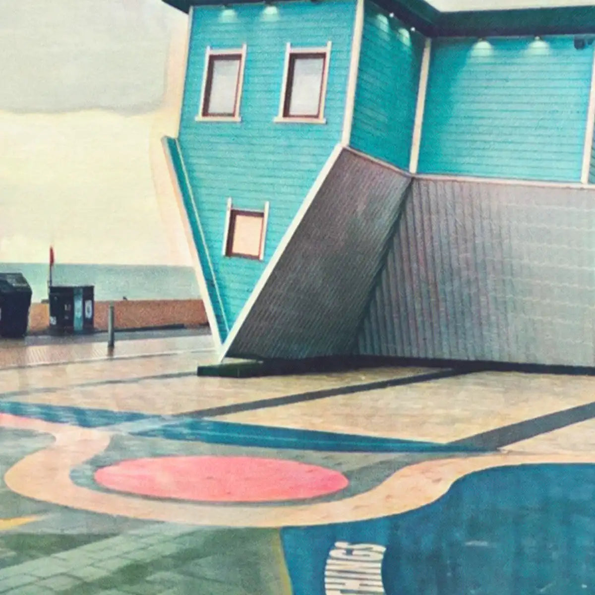Close-up of Brighton Upside Down House poster showing halftone grain, pastel colours, and inverted architecture