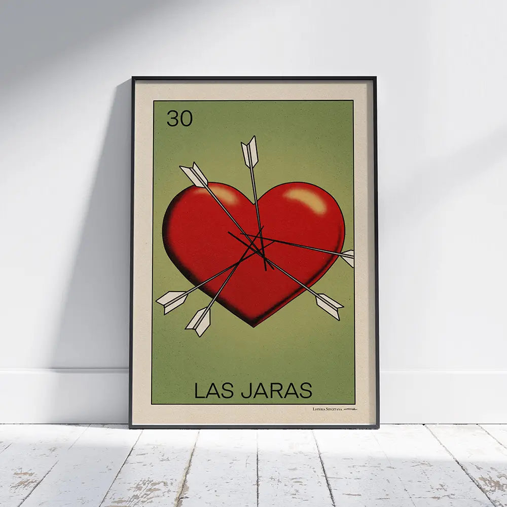 Framed Las Jaras Lotería poster by Cha leaning on floor, limited edition of 300 prints, depicting a symbolic heart pierced by arrows