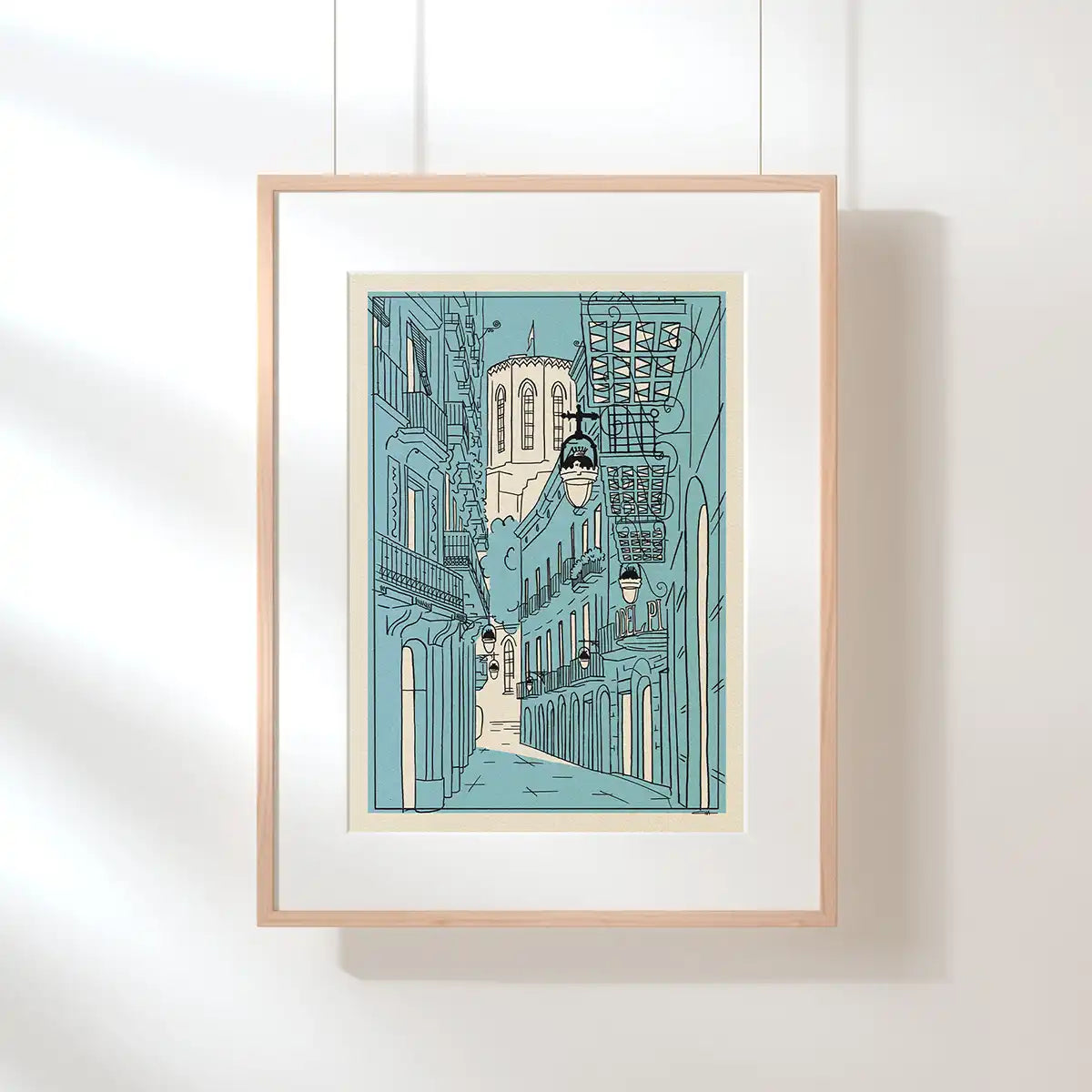 Santa Maria del Pi Barcelona art print by Cha, displayed in a natural wood frame against a bright interior wall.
