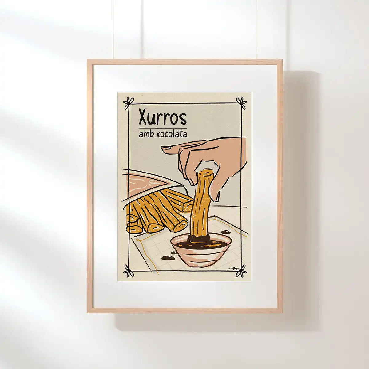 Xurros amb Xocolata poster by Cha, displayed in a natural wood frame and inspired by the classic Catalan churros and chocolate tradition.