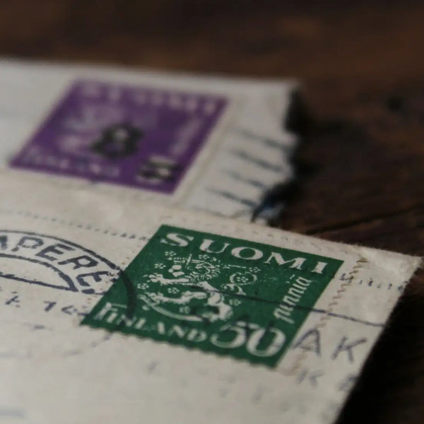 Vintage Finnish postage stamps on an old letter, inviting users to subscribe to ‘The Poster Chronicles’ newsletter for 10% off their first order