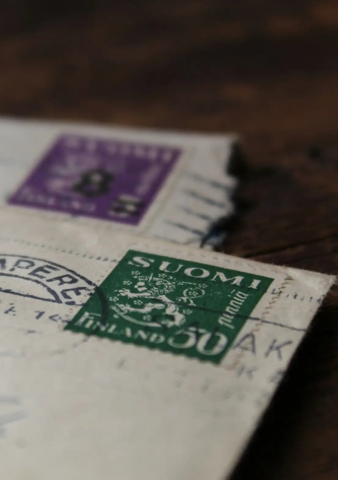 Vintage Finnish postage stamps on an old letter, inviting users to subscribe to ‘The Poster Chronicles’ newsletter for 10% off their first order