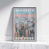 Brooklyn Perspective travel poster framed on a white wooden floor, showcasing Alecse’s exclusive limited-edition New York artwork