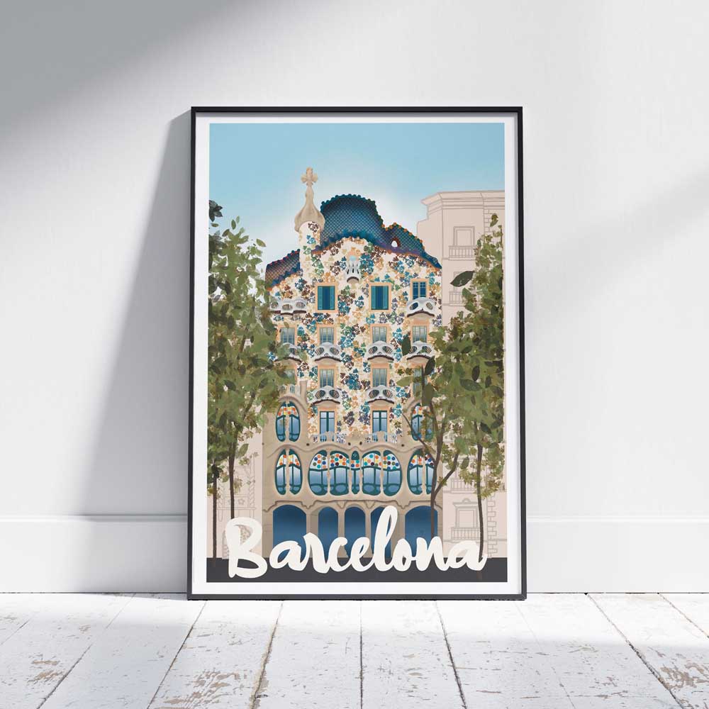 Barcelona Batlló vintage travel poster framed and leaning against a white wooden floor, featuring Gaudí’s colorful Casa Batlló facade.