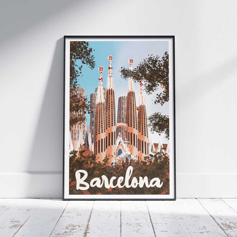 Barcelona Sagrada vintage travel poster framed and leaning against a white wooden floor, featuring the iconic Sagrada Família basilica