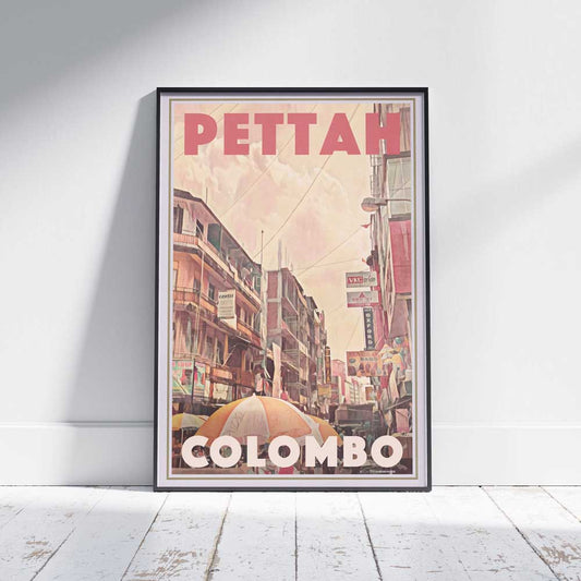 Travel poster of Colombo's Pettah Market framed on a white wooden floor, showcasing Alecse's exclusive limited edition art