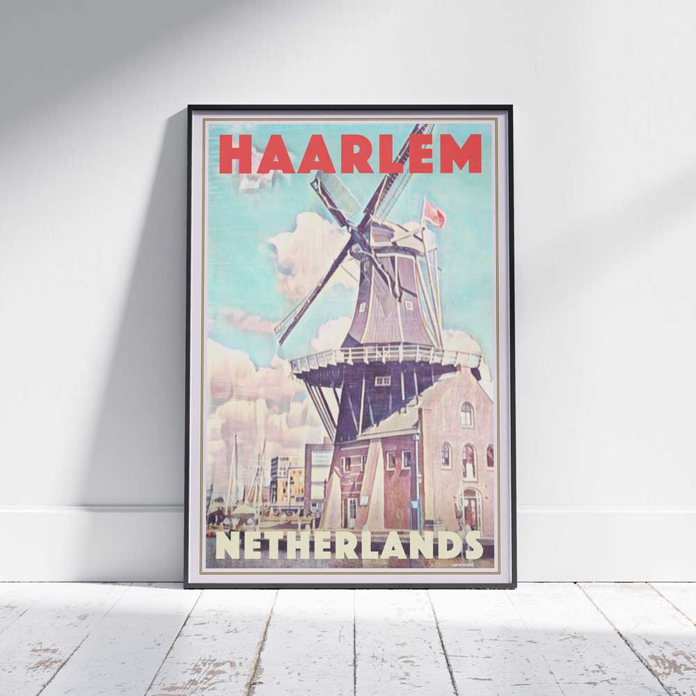 Framed limited edition travel poster of Haarlem's windmill on a white wooden floor—unique Dutch art by Alecse