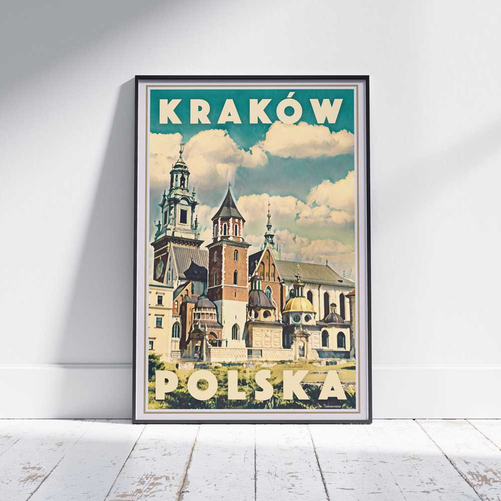 Vintage travel poster of Kraków Poland featuring Wawel Cathedral under a dramatic clouded sky, framed and displayed on wooden floor