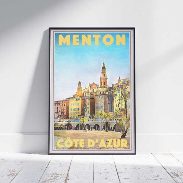 Travel poster of Menton in a frame on a white wooden floor