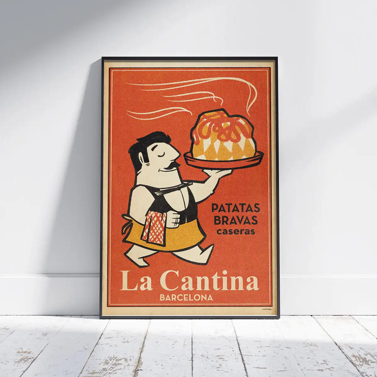 La Cantina Bravas poster framed on a white wooden floor, featuring a smiling waiter with a plate of patatas bravas