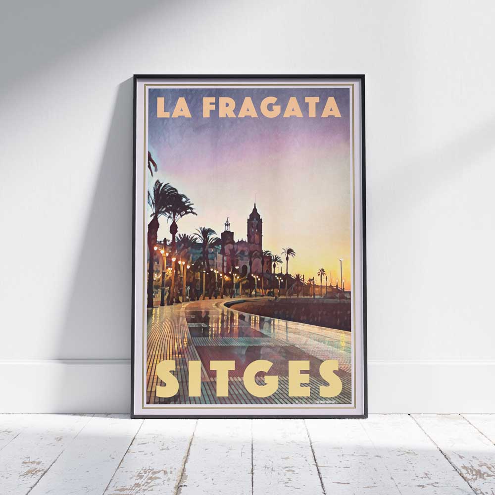 Framed travel poster of Sitges Fragata Sunrise winter morning on a white wooden floor, showcasing Alecse’s soft focus style and Mediterranean charm