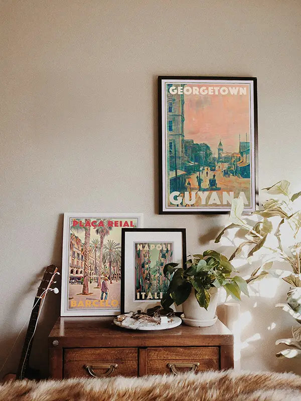 Best-seller posters 'Georgetown, Guyana', 'Plaça Reial, Barcelona' and 'Napoli, Italia' displayed in a modern interior, showcasing one of Myretroposter’s most popular wall art