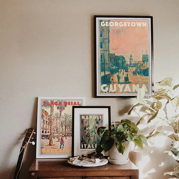 Best-seller posters 'Georgetown, Guyana', 'Plaça Reial, Barcelona' and 'Napoli, Italia' displayed in a modern interior, showcasing one of Myretroposter’s most popular wall art