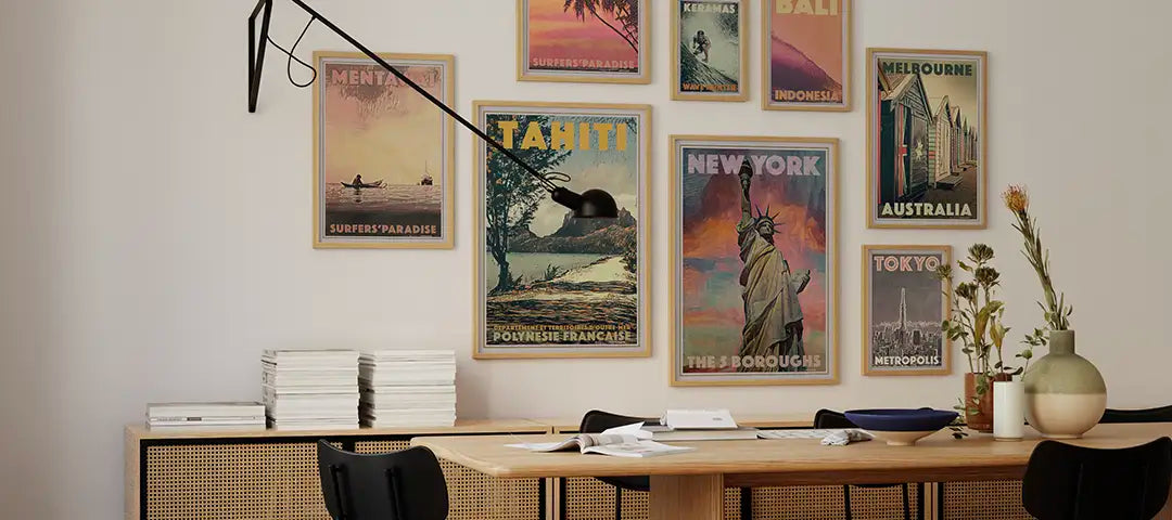 Modern dining room with a wooden table, chairs and exclusive collector edition travel posters by Alecse on the wall.