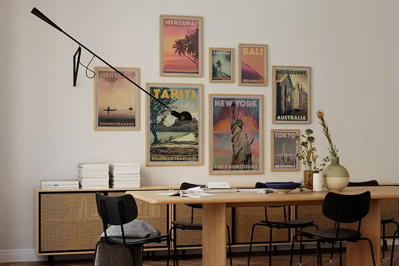 Modern dining room with a wooden table, chairs and exclusive collector edition travel posters by Alecse on the wall.