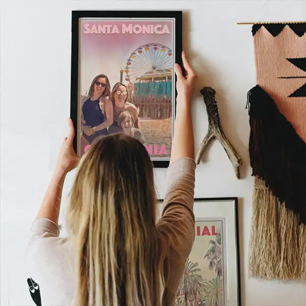 Custom family travel poster by Alecse featuring a family in Santa Monica, displayed framed as personalized wall art in a home interior.