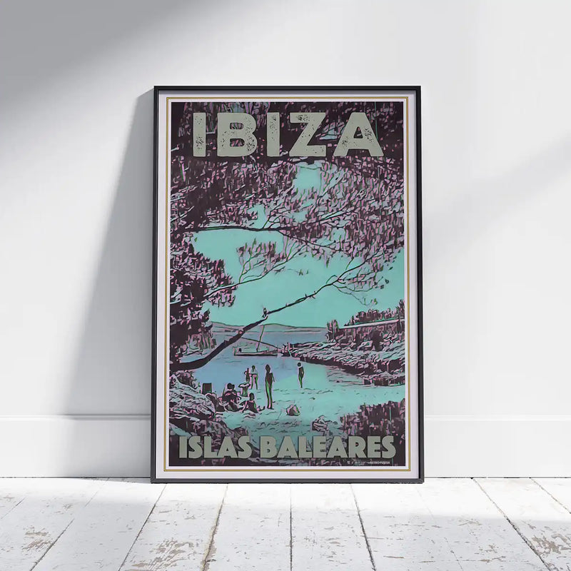 San Antonio Beach Vintage Ibiza poster by French Artist Alecse, showcased framed on a white wooden floor