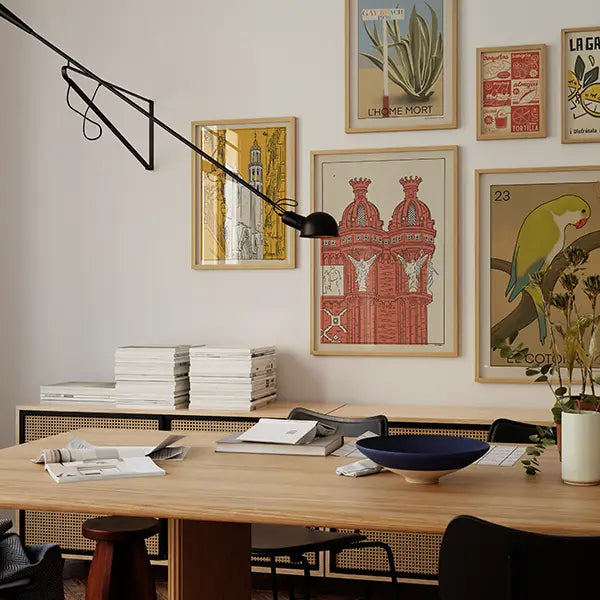 Playful and colorful wall art from the Spanish Capsule™ collection by Cha, featuring retro-style posters of scenic views of Barcelona, beach scenes, and vintage loteria-inspired designs.