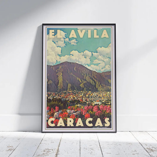 El Ávila Caracas vintage travel poster by Alecse framed on a wall, showing the mountain, the city skyline and colourful foreground flowers