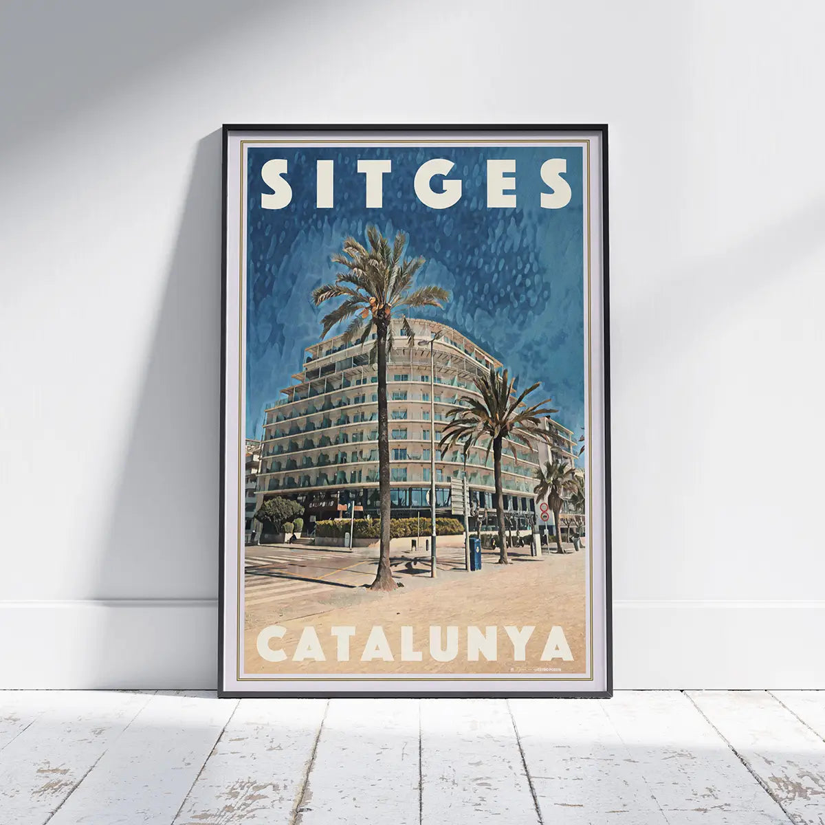 Passeig Marítim Poster Sitges by Alecse displayed in a black frame featuring the Calipolis Hotel, palm trees and Sitges seafront, limited edition travel poster
