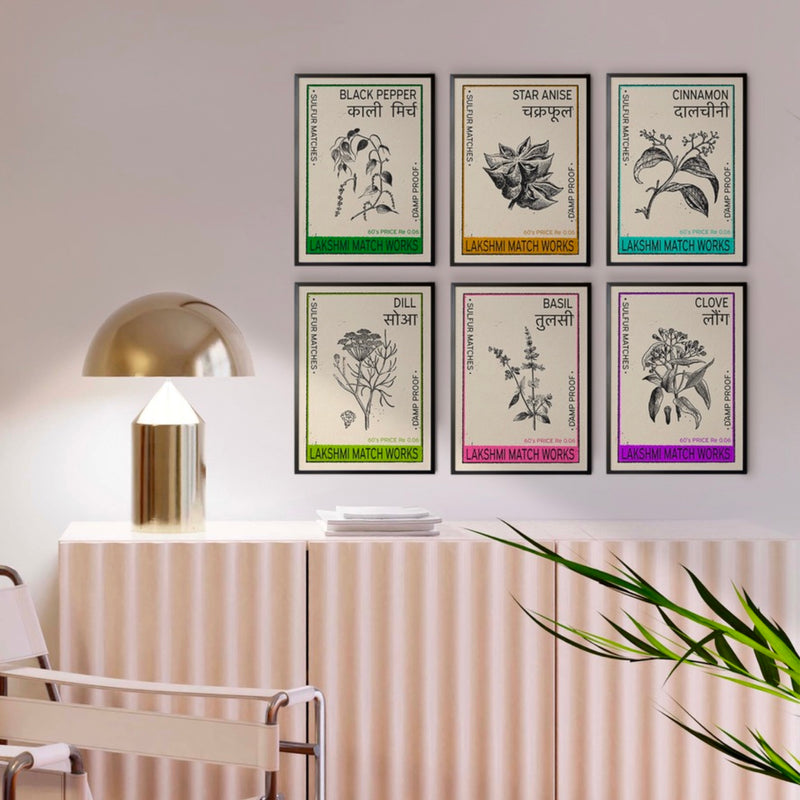 Set of six vintage Indian spice posters framed and arranged on a modern interior wall. Each poster features botanical illustrations of Black Pepper, Star Anise, Cinnamon, Dill, Basil, and Clove, inspired by retro Indian matchbox designs. Perfect for Indian vintage decor, heritage artwork, botanical wall art, and kitchen prints