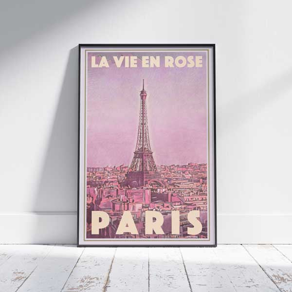 Framed La Vie en Rose Paris travel poster on white wooden floor – a vintage-style Paris artwork by Alecse featuring the Eiffel Tower