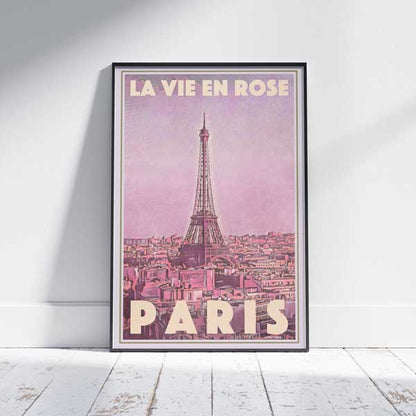 Framed La Vie en Rose Paris travel poster on white wooden floor – a vintage-style Paris artwork by Alecse featuring the Eiffel Tower