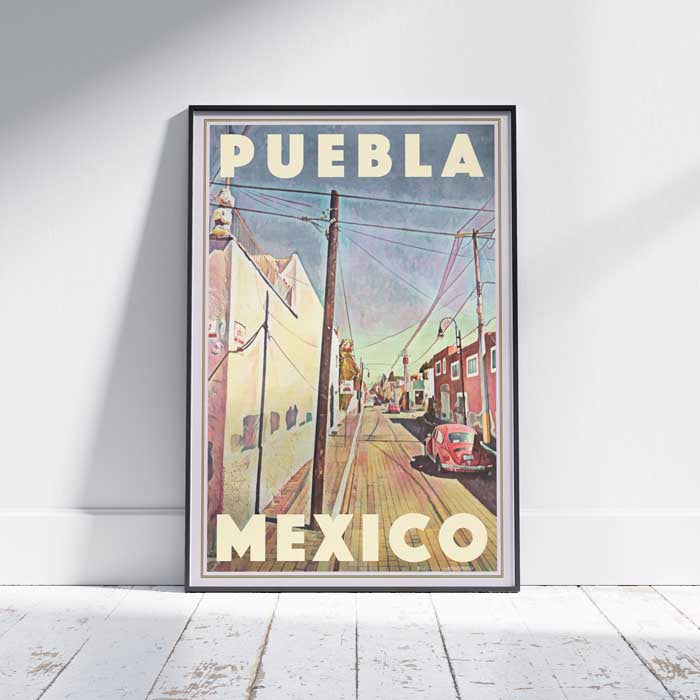 Puebla VW Travel Poster' in frame on a white wooden floor showcasing the streets of Puebla, Mexico