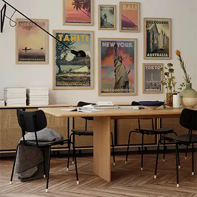Collector Editions wall with framed vintage travel posters above a dining area.